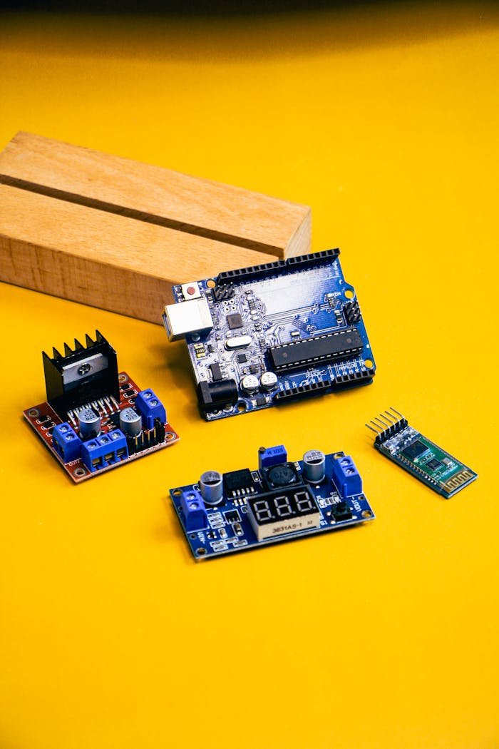 about-us-02 A detailed view of various robotics components set against a bold yellow backdrop, perfect for tech enthusiasts.